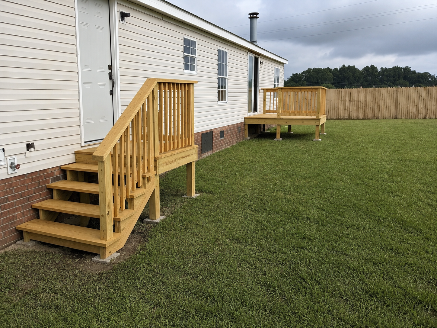 Clean yard and finished deck access after exterior cleanup