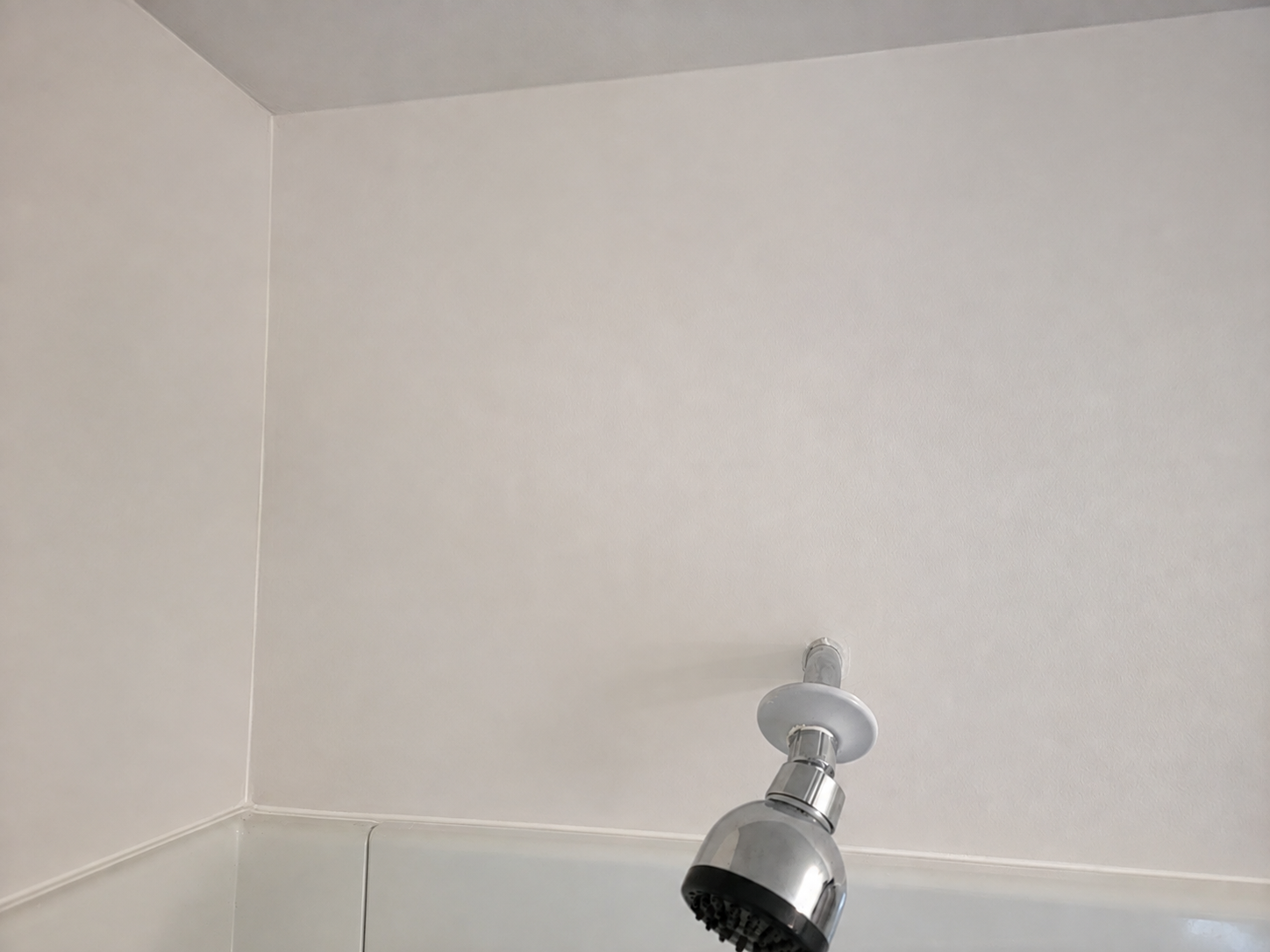 Smooth finished bathroom wall after repair and painting