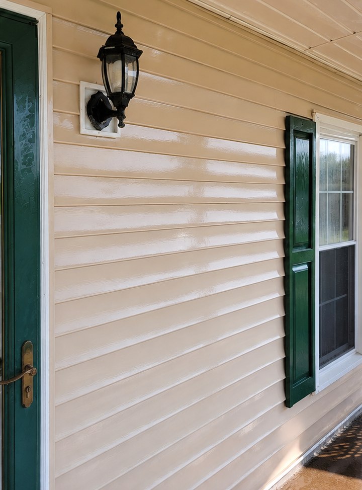Bright, evenly finished exterior siding with crisp white trim after refinishing